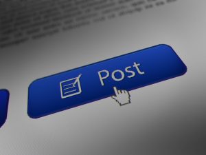 closeup of someone clicking “Post” button