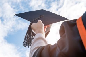 A Dreamer holding a graduation cap