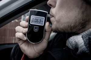 person using a breathalyzer